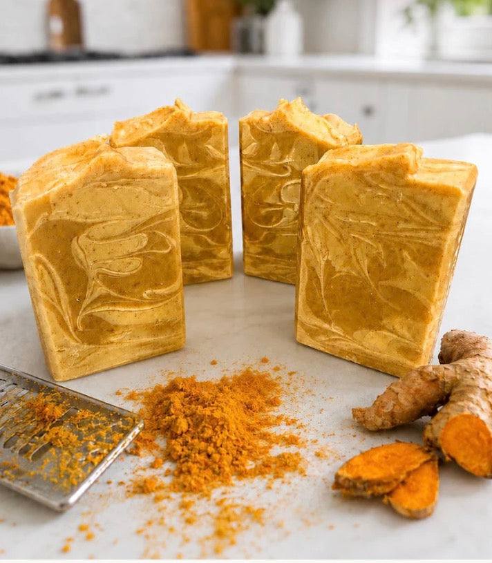 Goat Milk Base Turmeric soap bars in golden orange with marbled swirls and a handmade textured finish