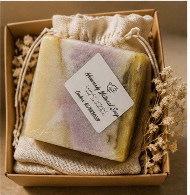 Lavender Oatmeal and Calendula soap bar with a pale yellow, lavender, and green marbled pattern, wrapped in clear film