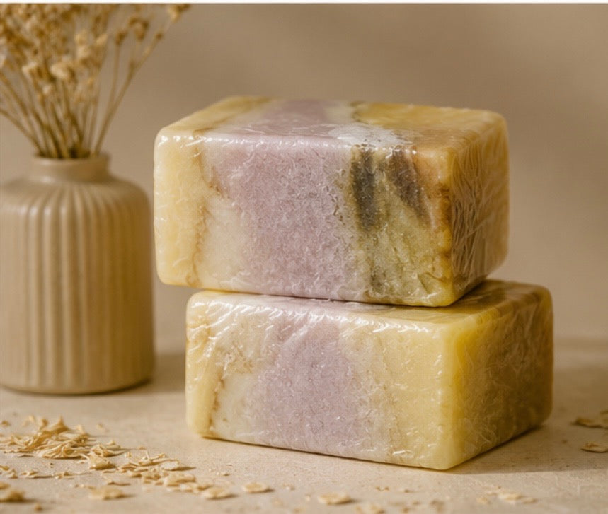 Lavender Oatmeal and Calendula soap bars in creamy yellow and pale lavender tones, with visible botanical flecks