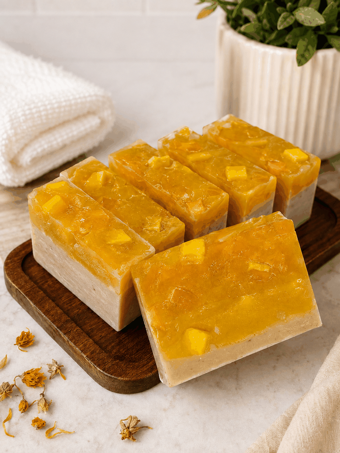 Patchouli Soapbar with a vivid amber-orange top, creamy beige base and visible chunky botanical pieces.