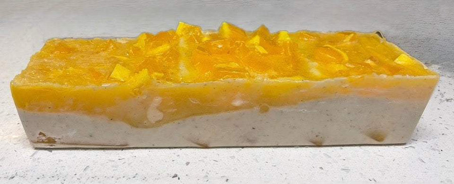 Patchouli Soapbar with a creamy white soap base and vivid golden yellow top, featuring a rough, chunky surface